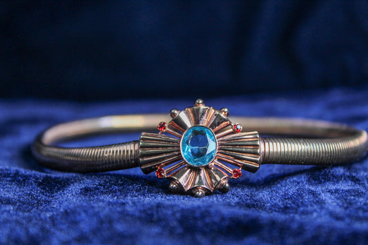 10K rose gold filled choker necklace with a blue glass center stone and ruby accents on a snake chain.