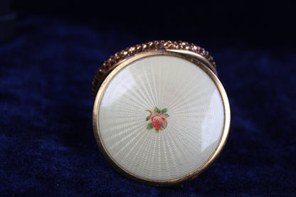 1930s-1940s gold tone compact with guilloché enamel lid featuring a rose motif.