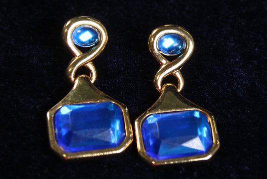 Jaestial Countess 80's blue and gold statement earrings with large rectangular blue gems.