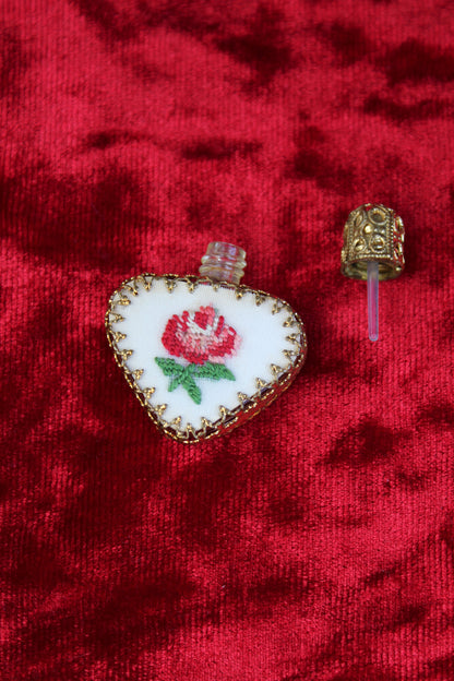 Austrian heart-shaped perfume bottle with petit point rose embroidery and gold filigree.