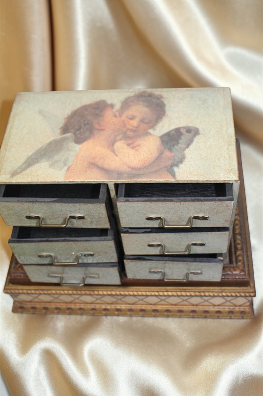 Jaestial Vintage Cherub Drawer Chest with six drawers and a painting of two cherubs on top.