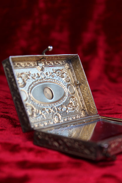 Antique French vanity case with ornate silver and brass detailing, featuring a swan scene.
