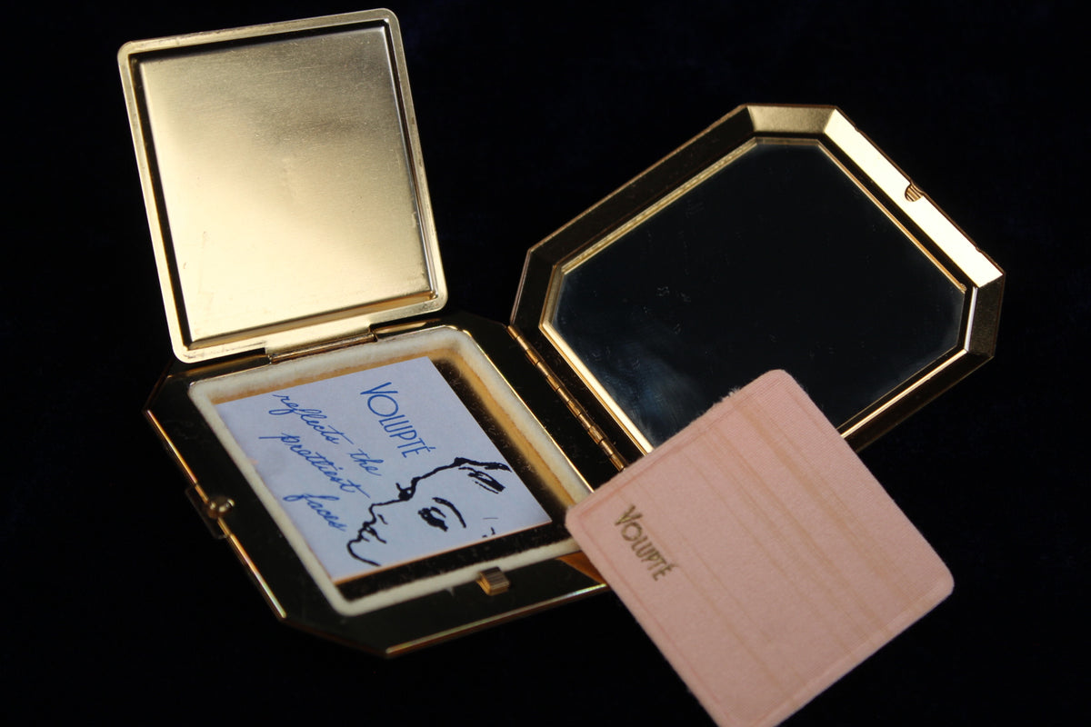 1950s Volupte octagonal gold-tone compact with mirror, powder puff, and insert card.