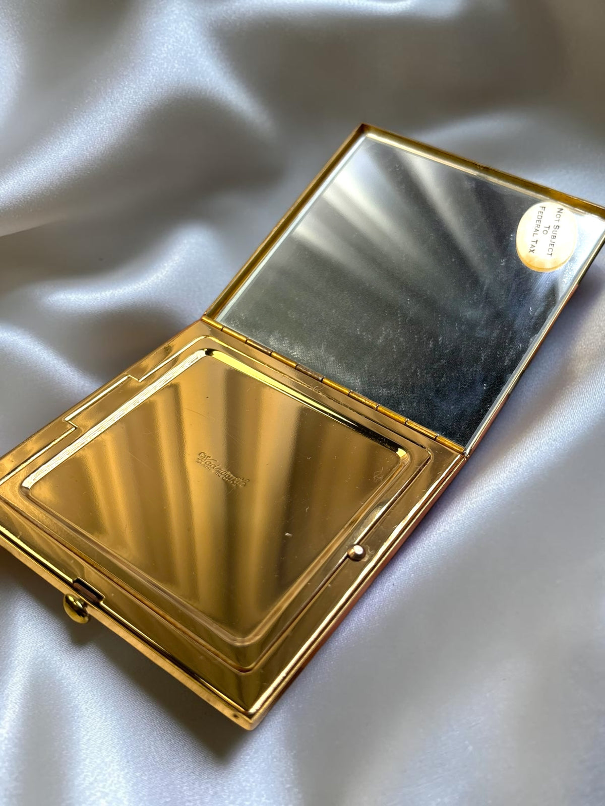 Gold-tone Wadsworth powder compact open, showing mirror and powder compartment.