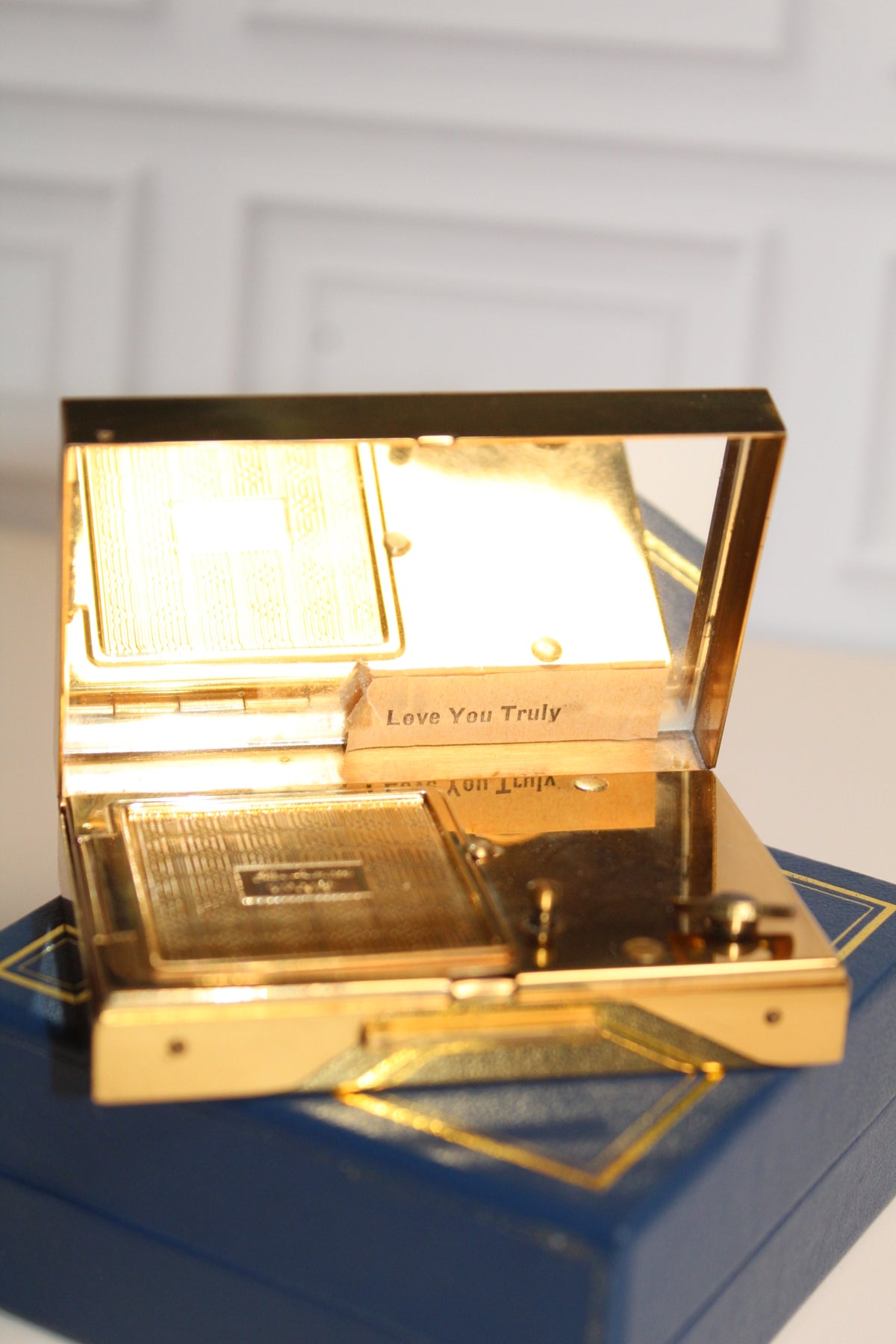 Gold musical compact playing "Love You Truly" with a mirrored lid and floral engraving.