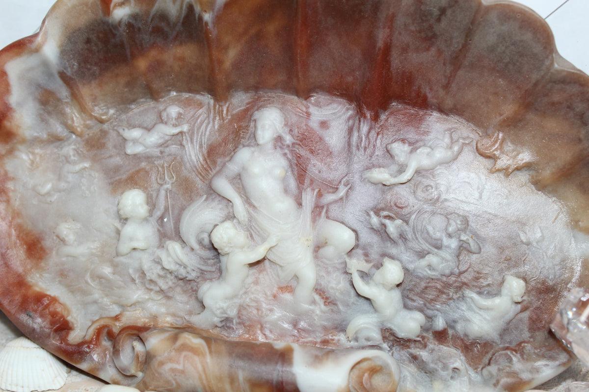 Incolay jewelry dish carved from shell with a goddess and cherubs.