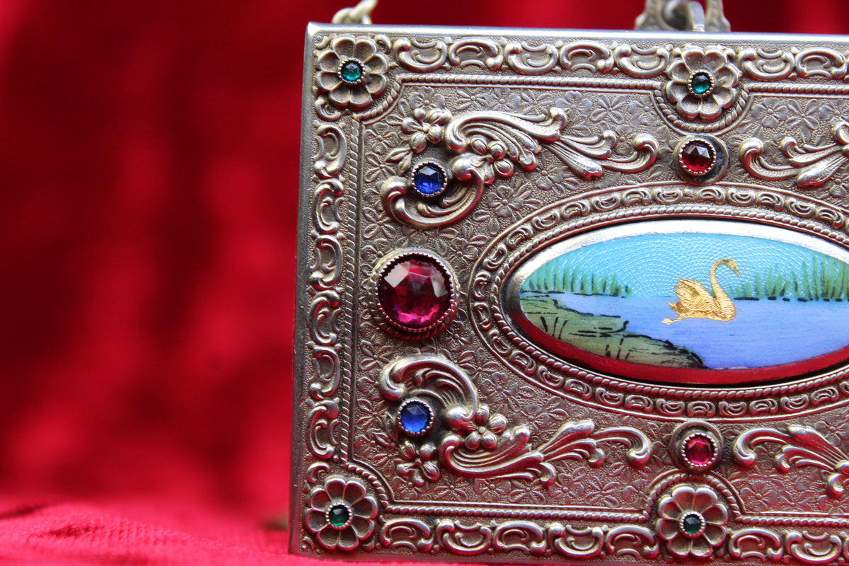 Antique French vanity case with swan scene, repoussé metalwork, and jeweled accents.