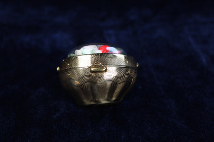 1940s gold-tone compact with preserved floral arrangement under a dome.