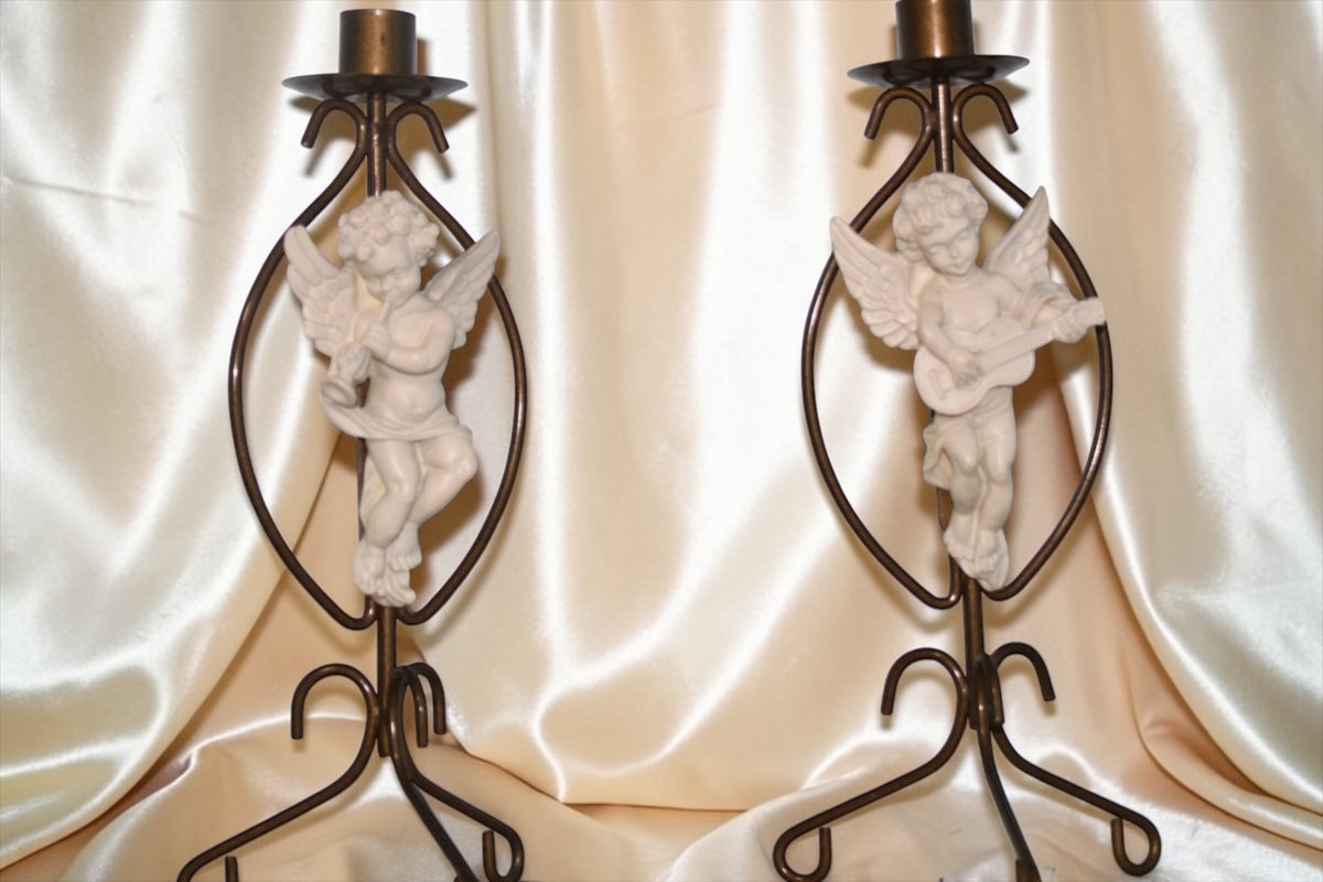 Set of 2 vintage brass cherub candle holders, each with a cherub holding a musical instrument.