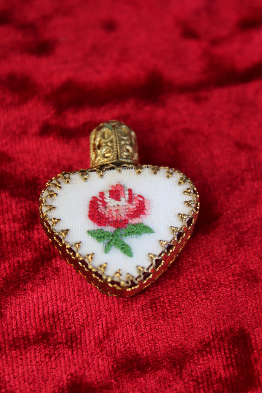 Austrian heart-shaped perfume bottle with gold filigree and petit point rose embroidery.