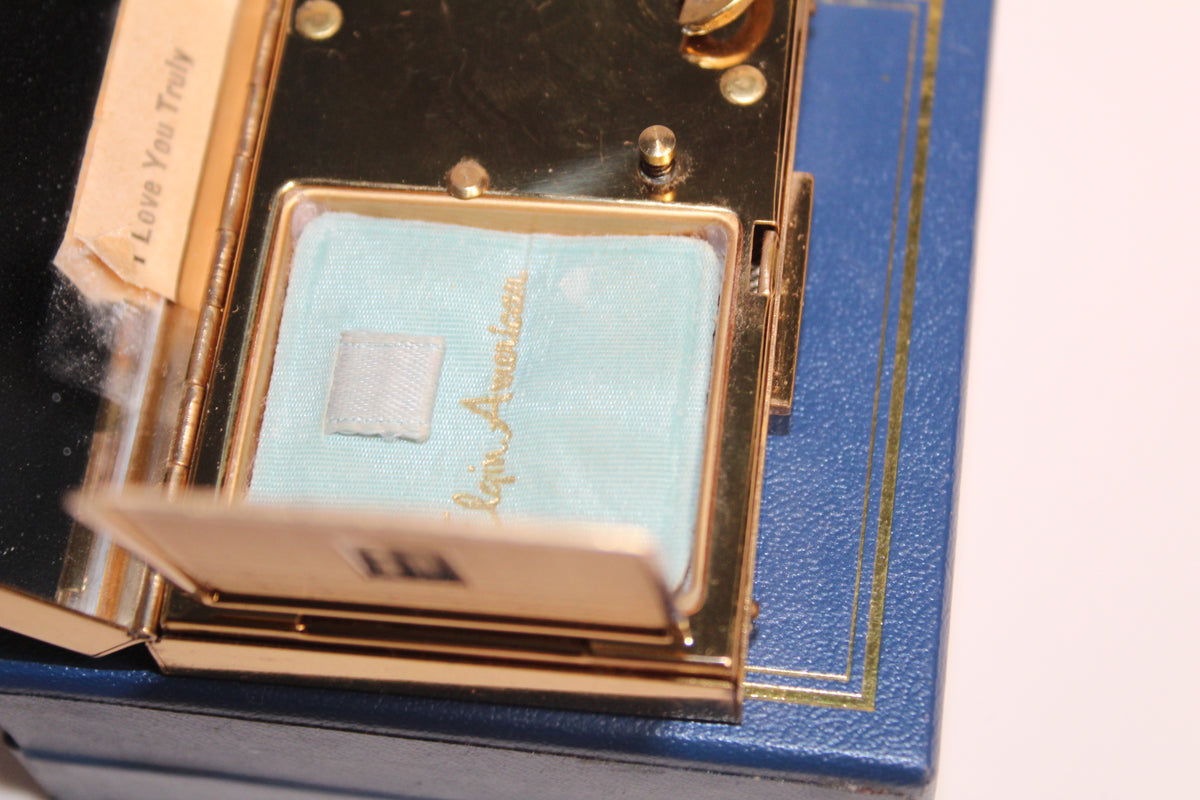 Gold musical compact with 'I Love You Truly' inscription and blue interior.