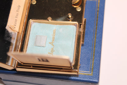 Gold musical compact with 'I Love You Truly' inscription and blue interior.