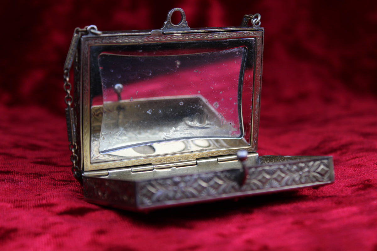 Antique French vanity case with ornate brass and silver guilloché detailing and a mirrored lid.