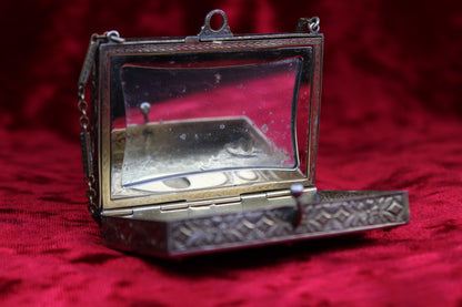 Antique French vanity case with ornate brass and silver guilloché detailing and a mirrored lid.