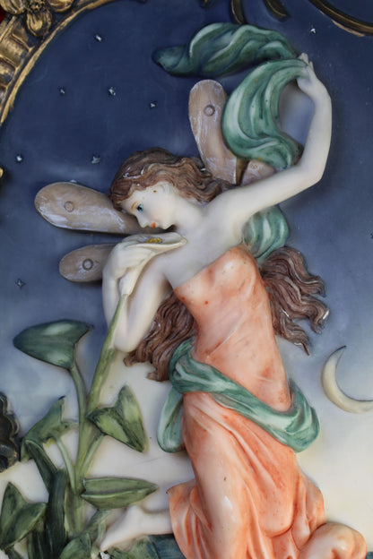 Vintage night fairy wall plaque with ornate gold frame, holding a flower against a starry sky.