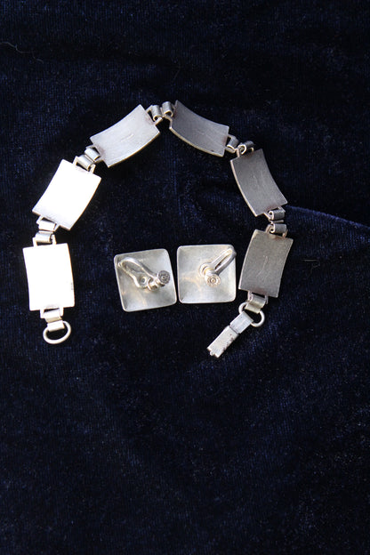 Sterling silver bracelet and square earrings with guilloché enamel rose design.