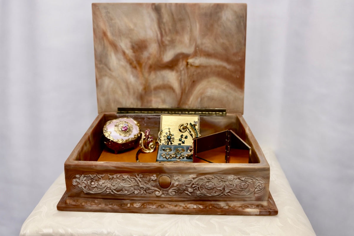 Jaestial hand-carved Incolay stone jewelry box with a fox hunting scene on the lid, open to reveal jewelry inside.