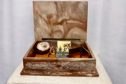 Jaestial hand-carved Incolay stone jewelry box with a fox hunting scene on the lid, open to reveal jewelry inside.