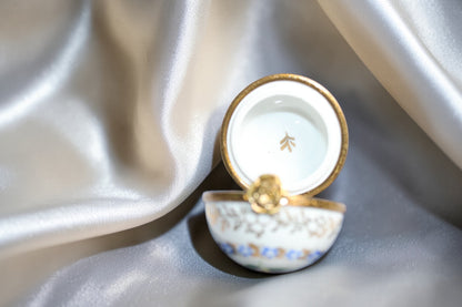 Jaestial hand-painted Limoges porcelain trinket egg with gold trim and floral design.