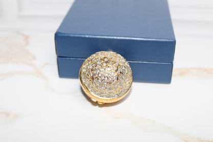 Jaestial Gilded Lace Round Trinket Box with gold filigree and shimmering accents.