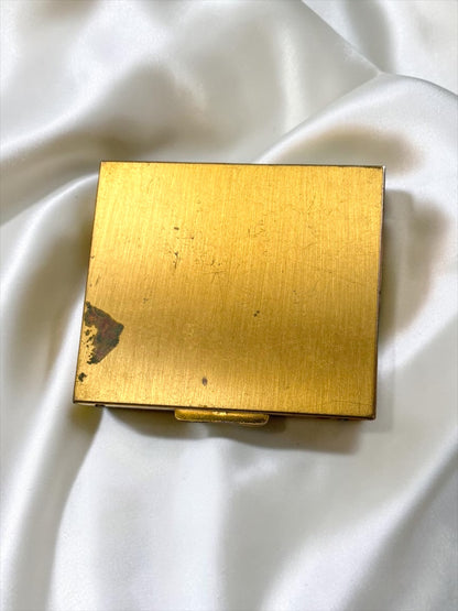 Brushed gold-tone S.F. Co. Fifth Avenue powder compact with a hinged closure, showing some patina.