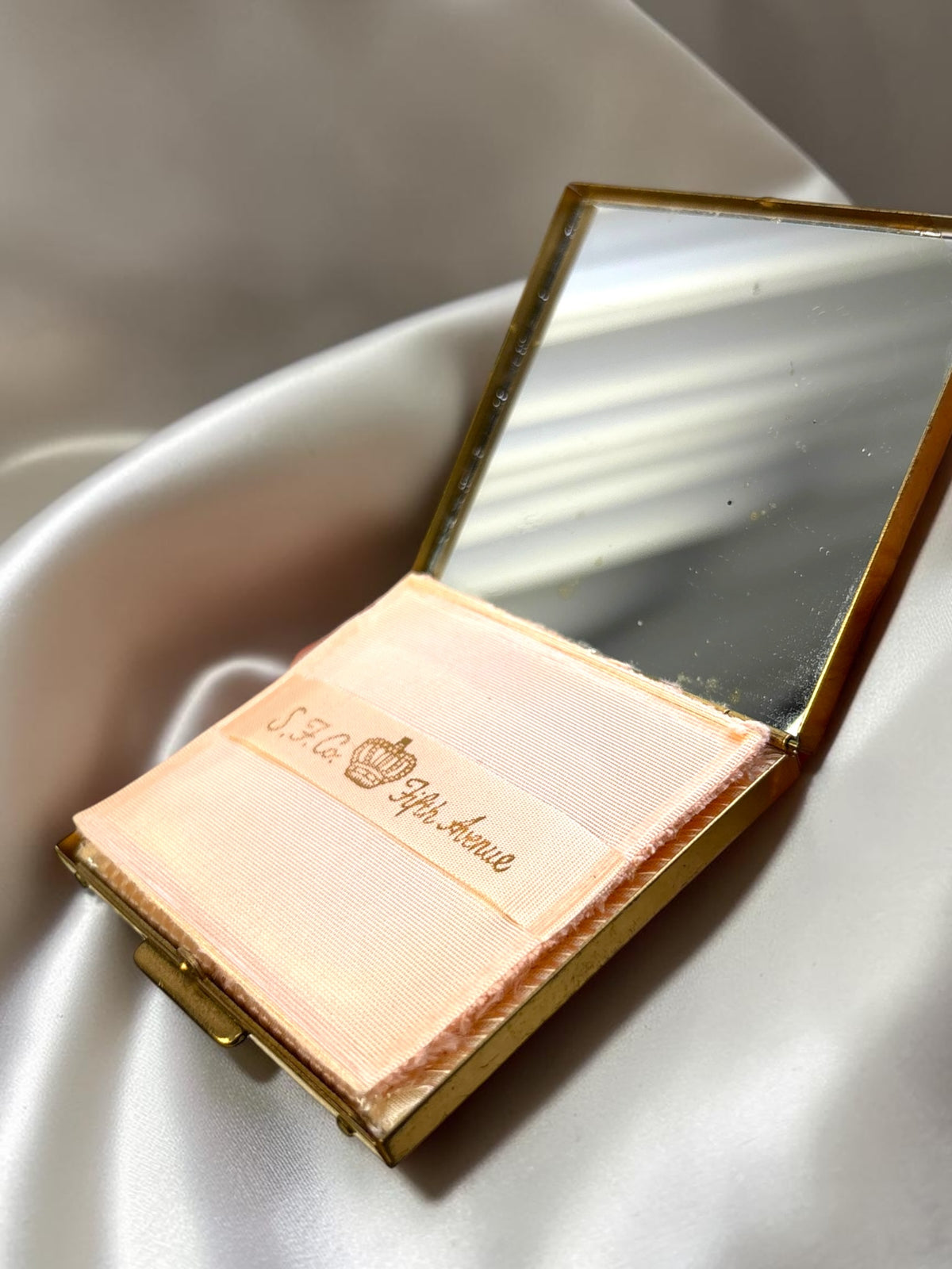 S.F. Co. Fifth Avenue gold tone powder compact with original puff and mirror.