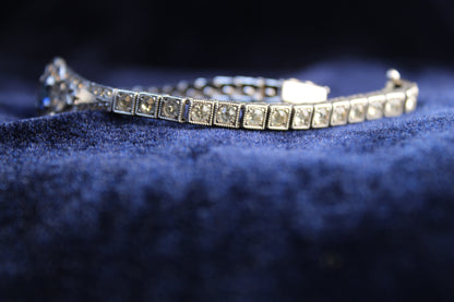 Sterling silver Art Deco bracelet with sapphire blue paste stones and clear paste accents.