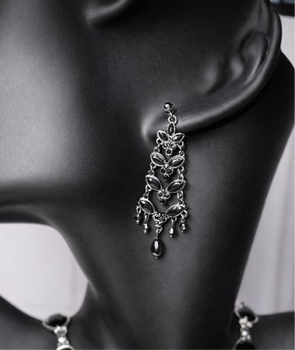 Black crystal chandelier earrings with a vintage design on a black mannequin.