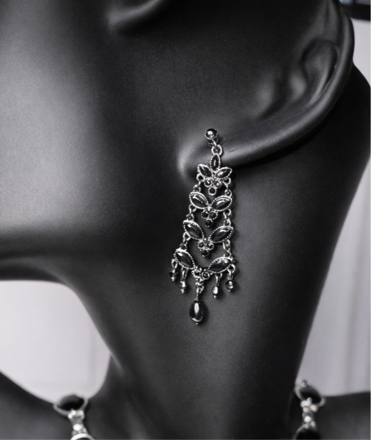 Black crystal chandelier earrings with a vintage design on a black mannequin.