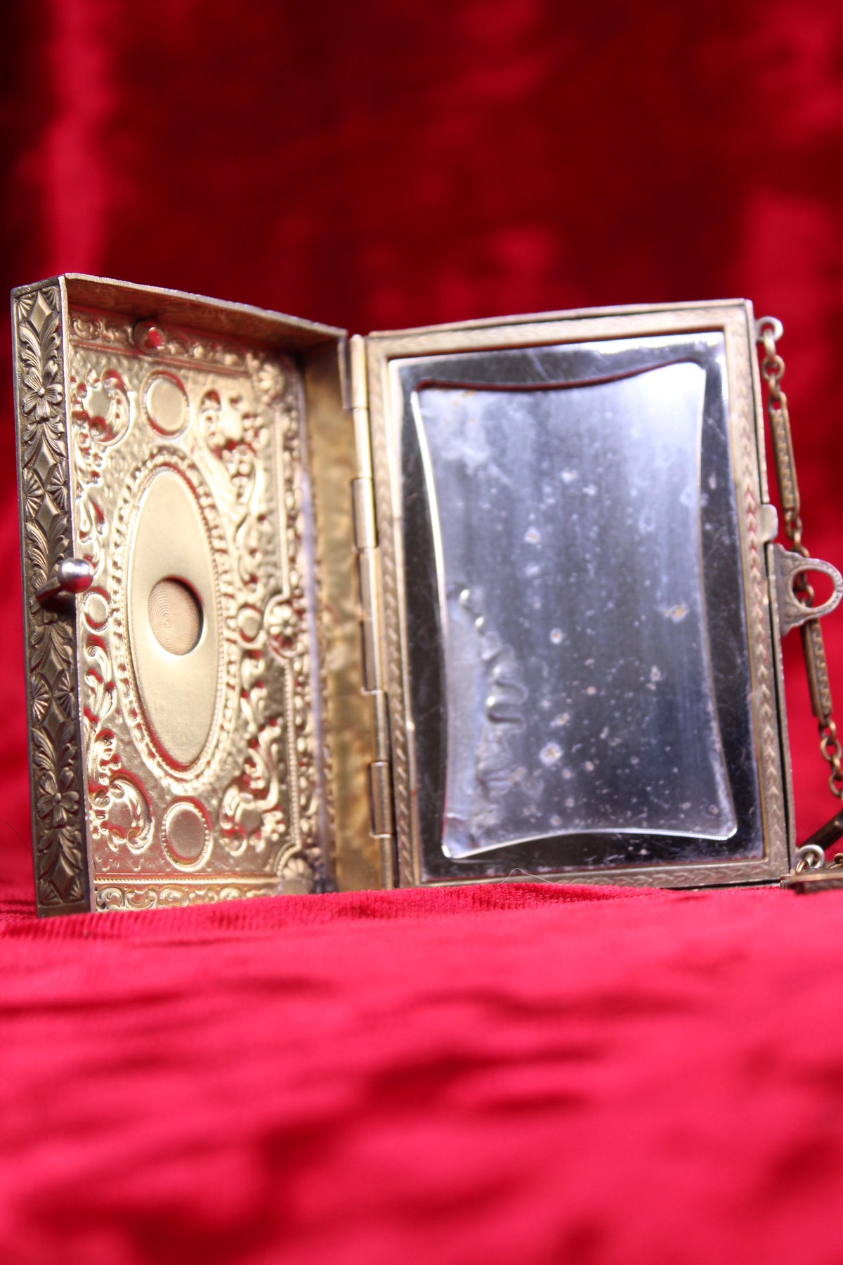 Antique French vanity case with ornate brass detailing and a mirrored interior.