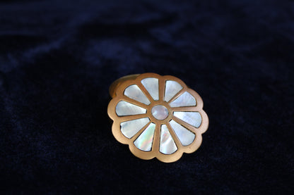Brass ring box with a floral design inlaid with mother of pearl.