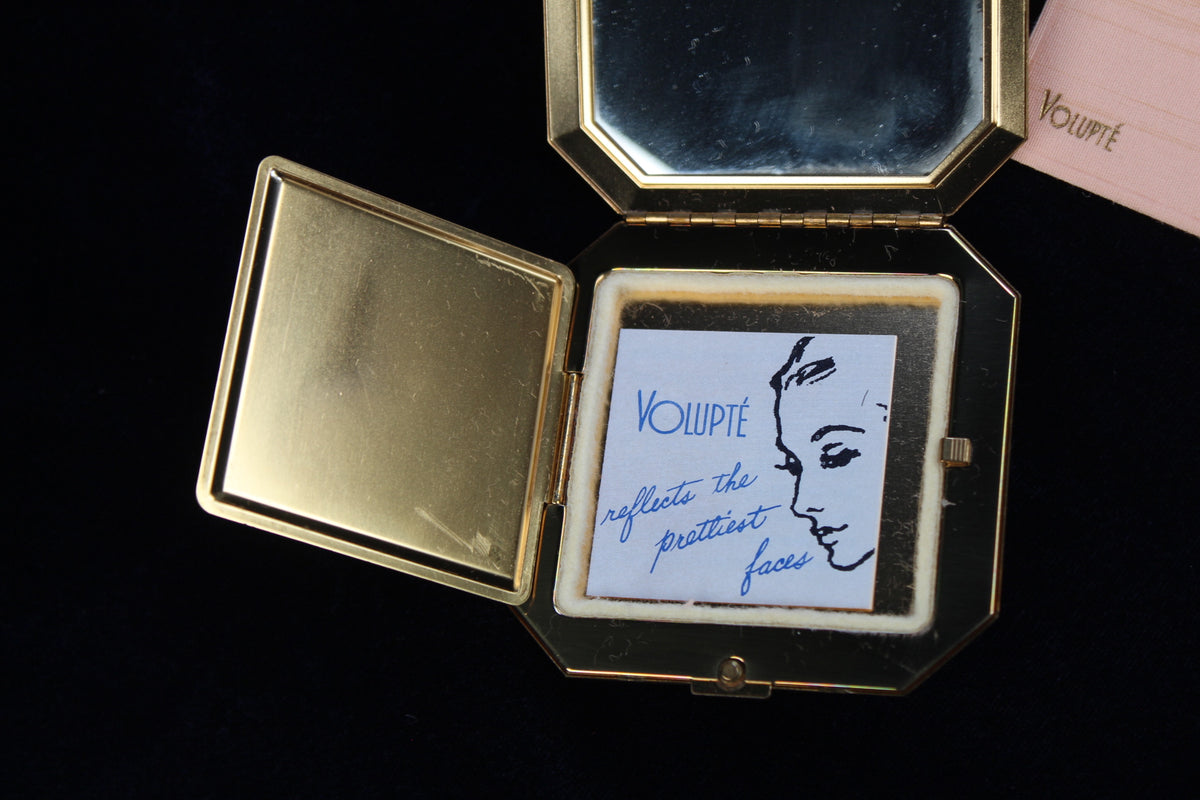 1950s Volupte octagonal gold-tone compact with rhinestone clasp and original insert.