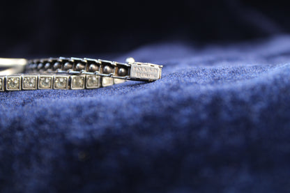 Sterling silver Art Deco bracelet with sapphire blue paste stones and geometric design.