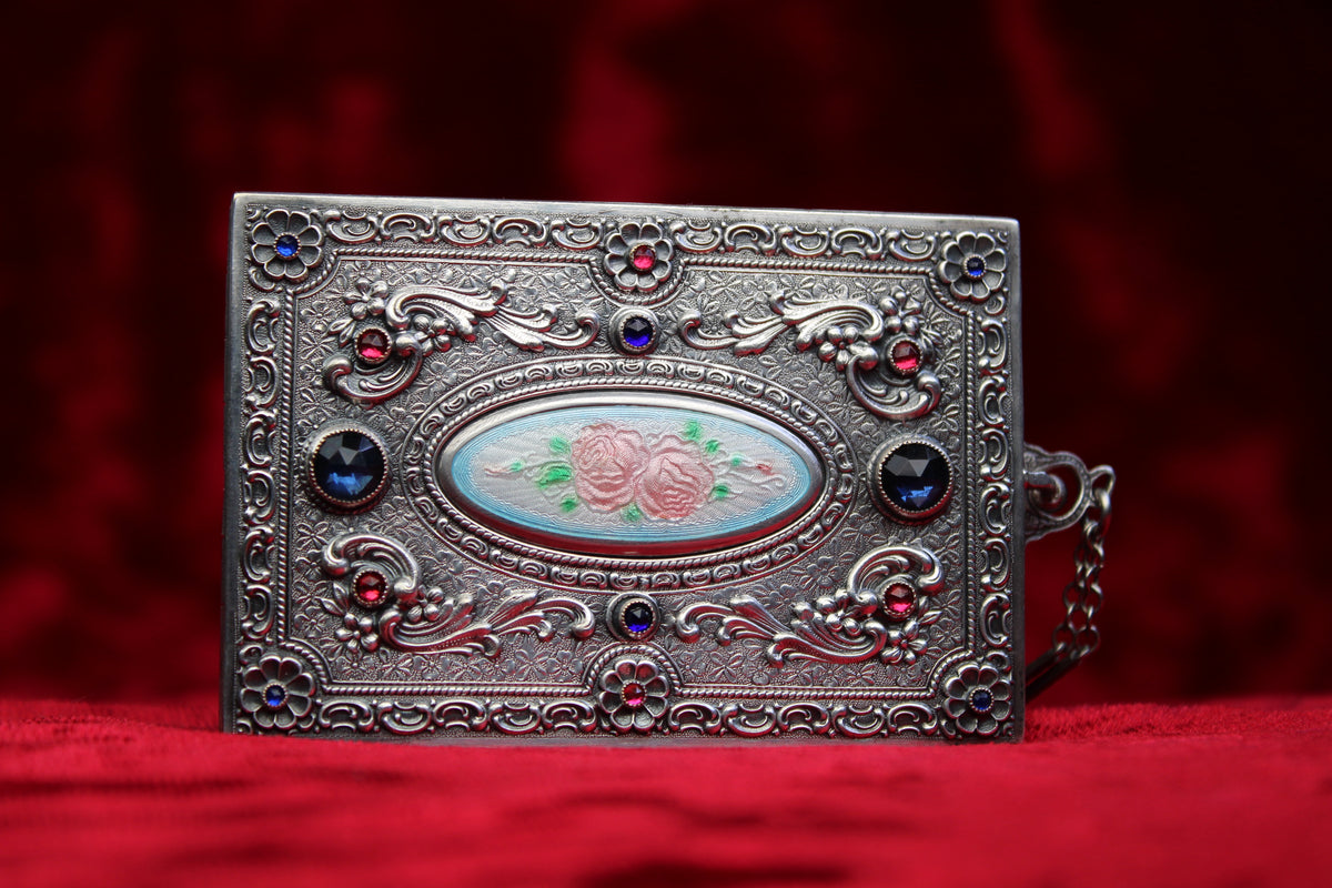 Antique French sterling silver compact with guilloché enamel roses and jewel accents.