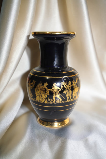 Black and gold miniature vase with Grecian procession motif, 5 inches tall.