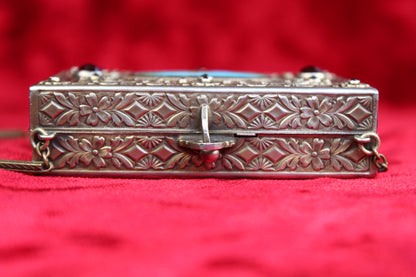 Antique French vanity case with floral repoussé metalwork and a clasp.