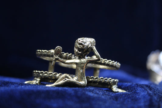 Gold-tone vintage lipstick holder with a figural girl holding a mirror and rose details.