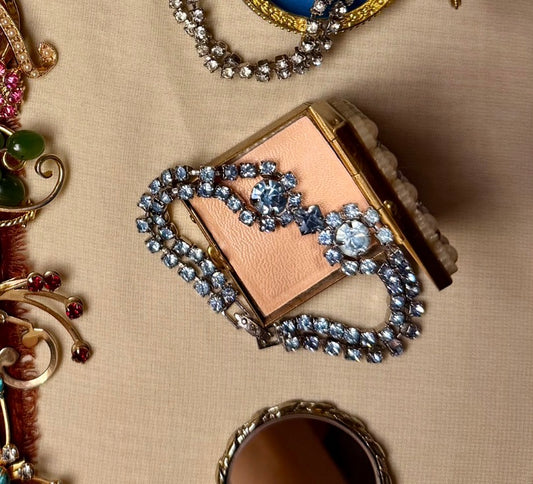 Jaestial Blue Radiance Tennis Bracelet with blue rhinestones on a pink compact.