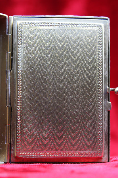 Antique French vanity case with intricate guilloché pattern and ornate metalwork.
