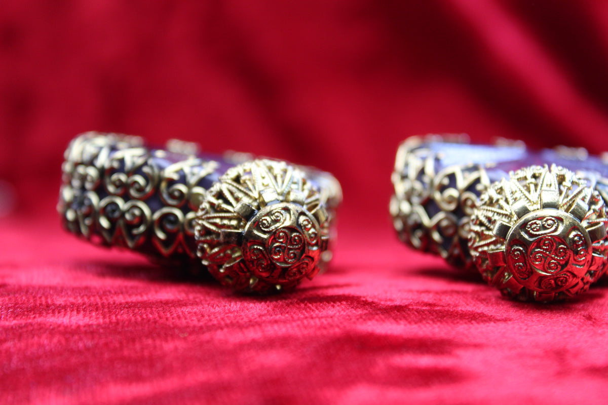 Matched pair of amethyst glass perfume bottles with gold-tone filigree on red velvet.