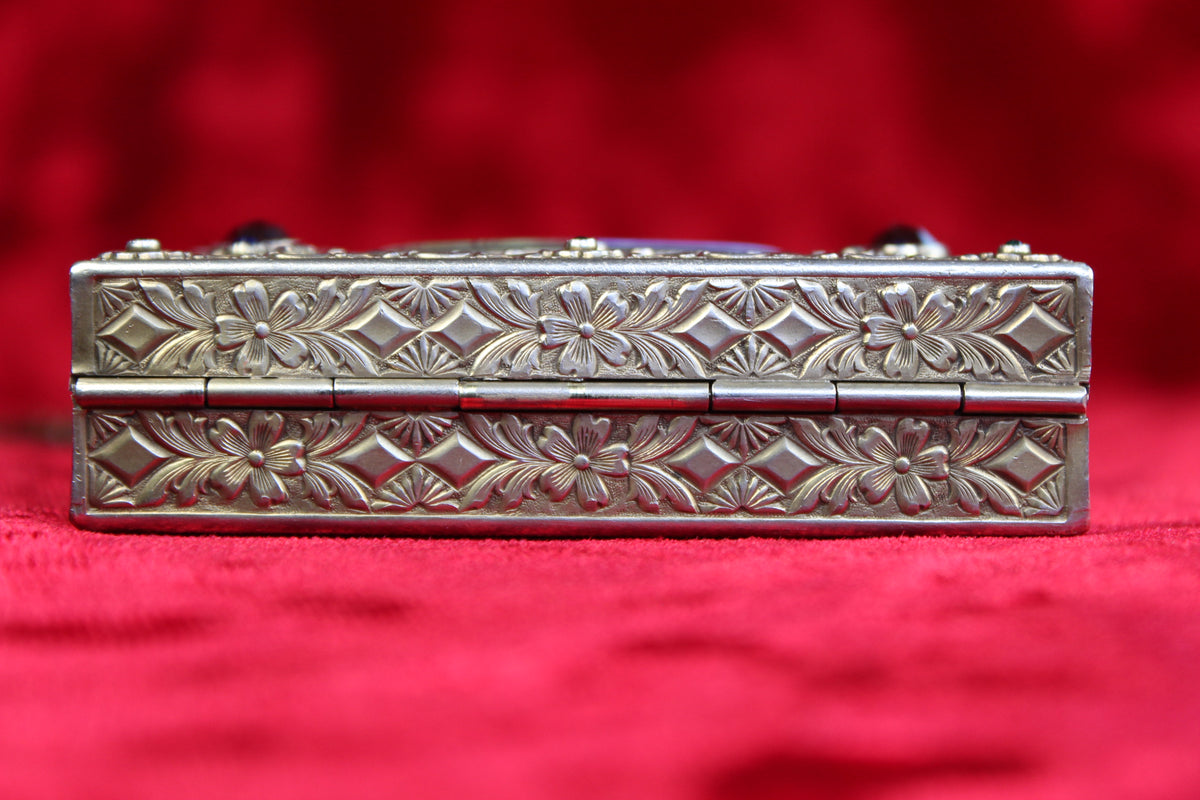 Antique French vanity case with ornate silver floral and diamond repoussé metalwork.