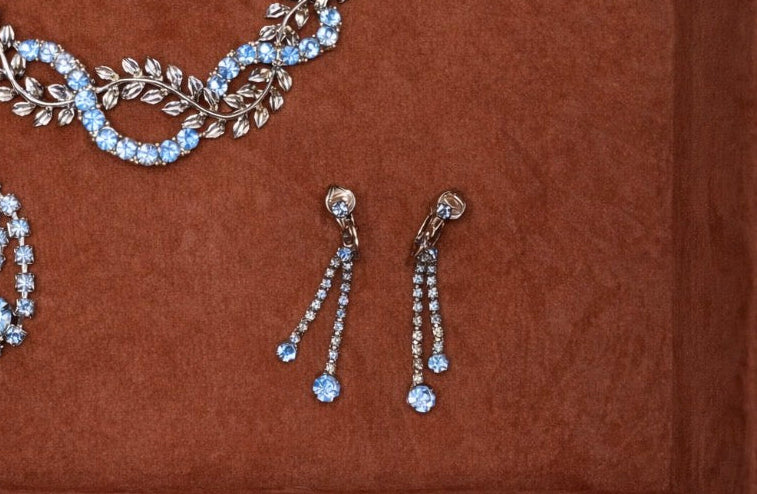 Jaestial blue teardrop clip-on earrings with shimmering stones.