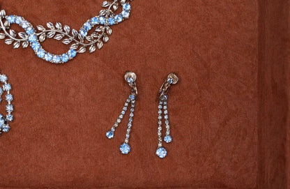 Jaestial blue teardrop clip-on earrings with shimmering stones.