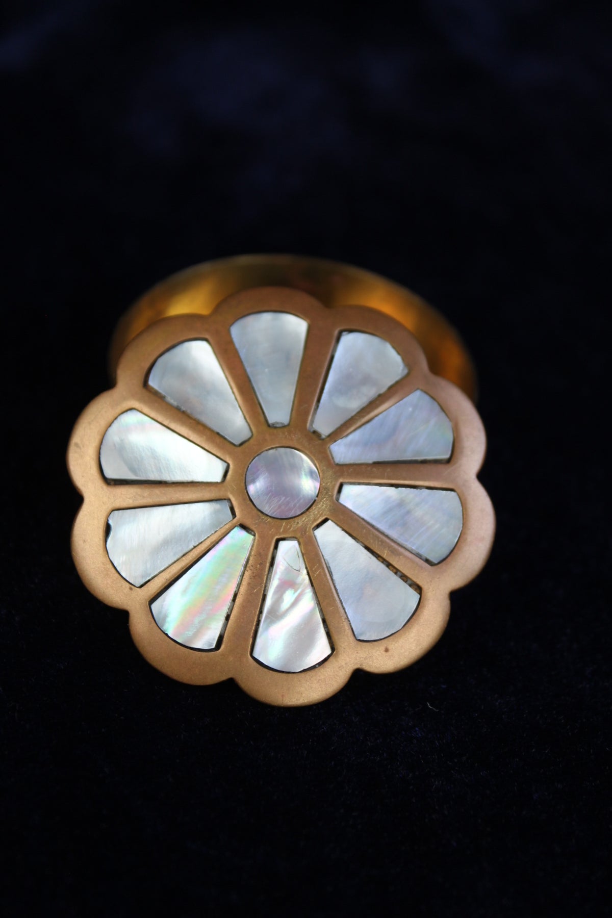 Brass ring box with a floral design inlaid with mother of pearl.