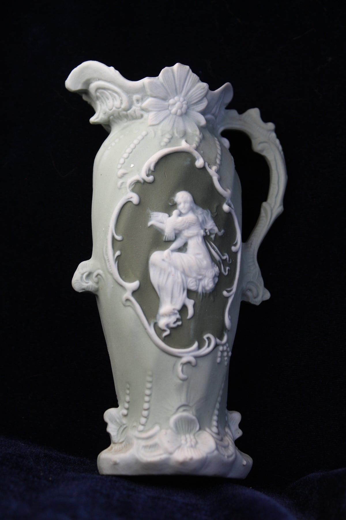 Sage green jasperware-style vase with ivory Art Deco detailing and a central cameo.
