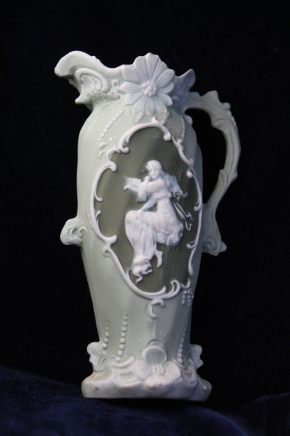 Sage green jasperware-style vase with ivory Art Deco detailing and a central cameo.