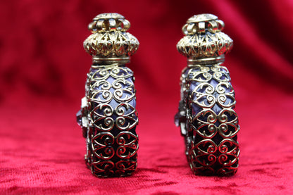 Matched pair of vintage amethyst glass perfume bottles with gold-tone filigree and rhinestone details.