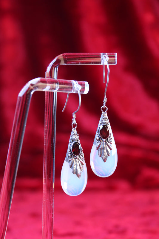 Sterling silver dangle earrings with red garnets and opalite teardrops.