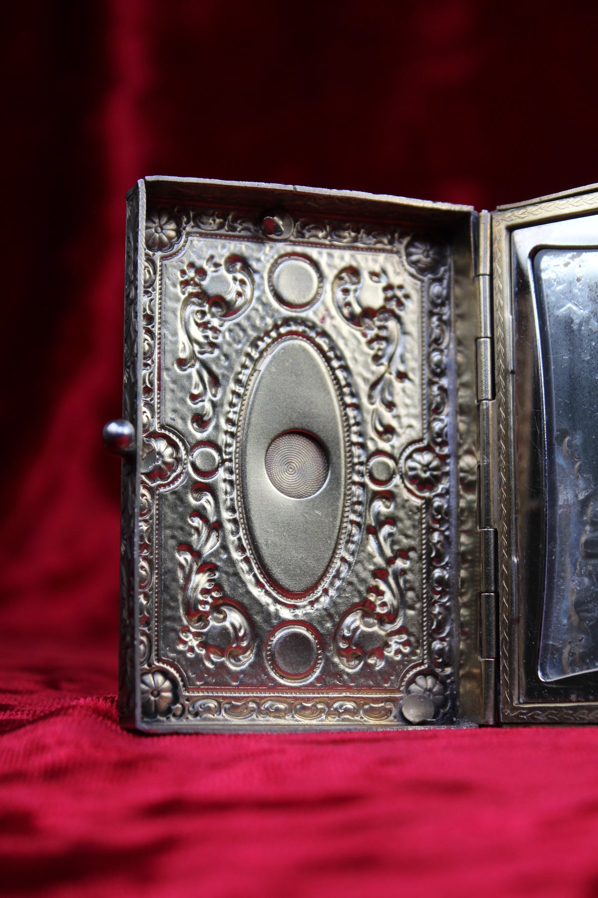 Antique French vanity case with ornate repoussé metalwork and guilloché detailing.