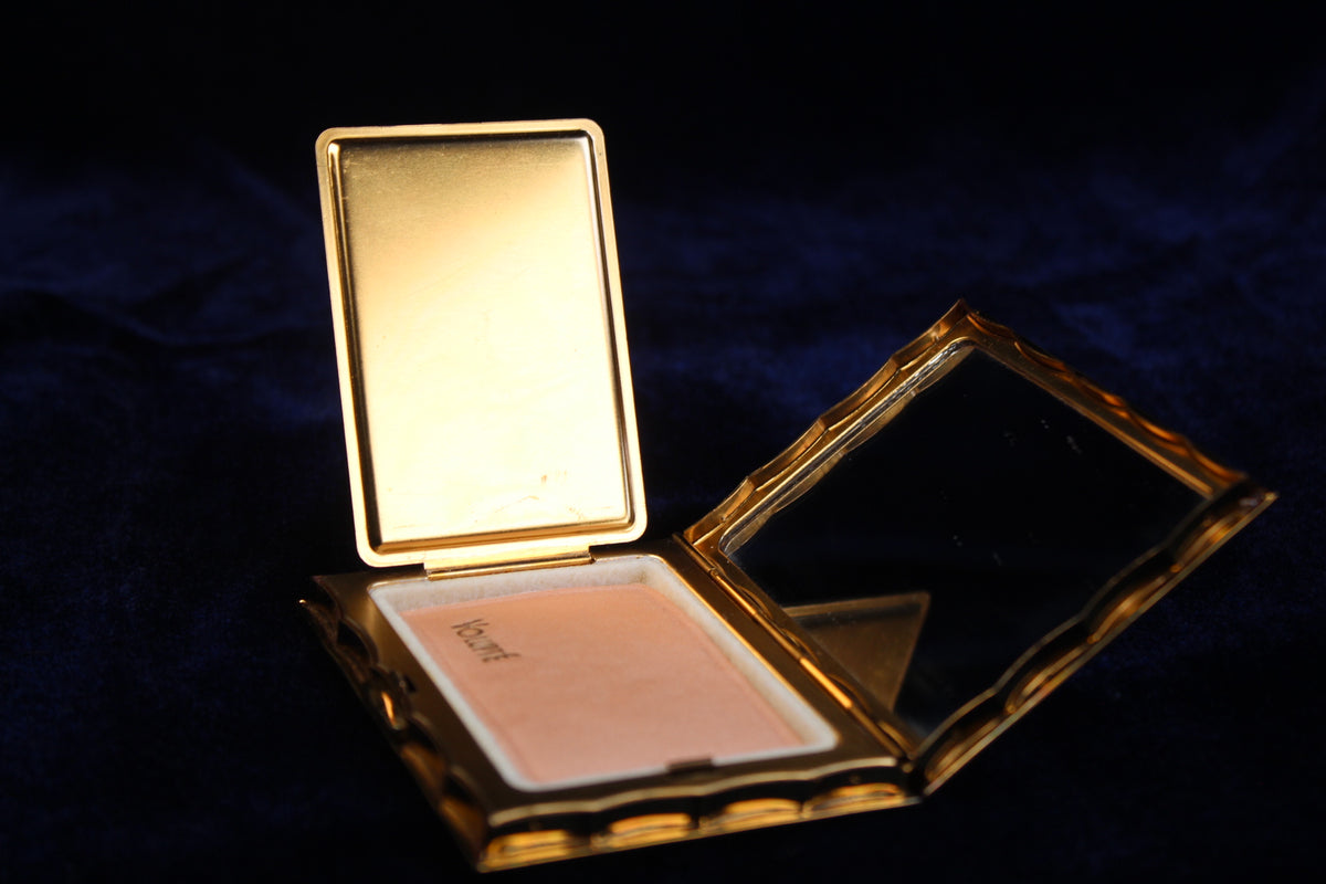 1940s gold-tone Volupte compact open, showing powder and mirror.